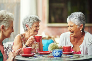 social wellness - 3 happy ladies having coffee