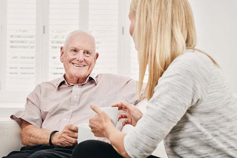 family-caregiver-talking-to-senior-man