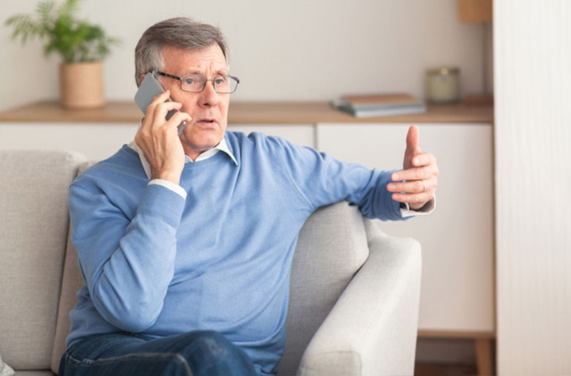 A senior man speaking on his phone knows that technology is making scams more complex to uncover.