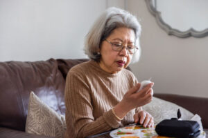 A woman checks her blood sugar as part of managing diabetes in seniors.